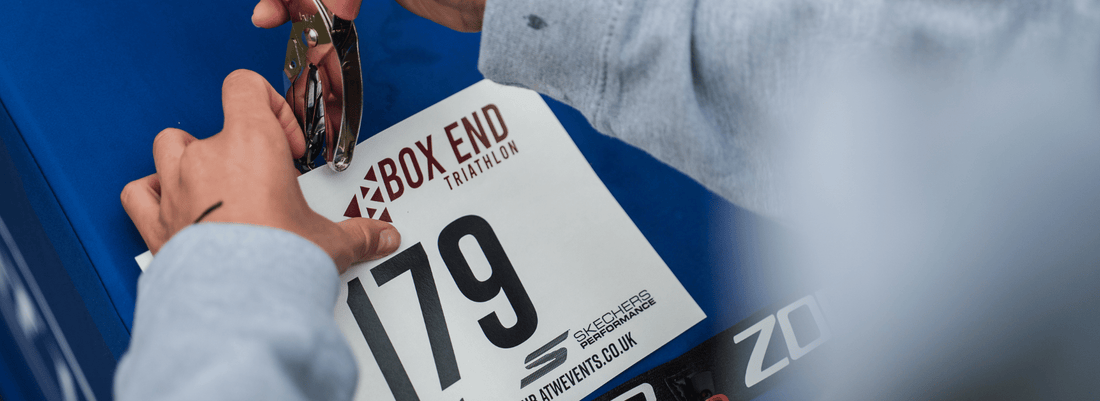Close-up of a triathlete holding race number 79 against their kit.