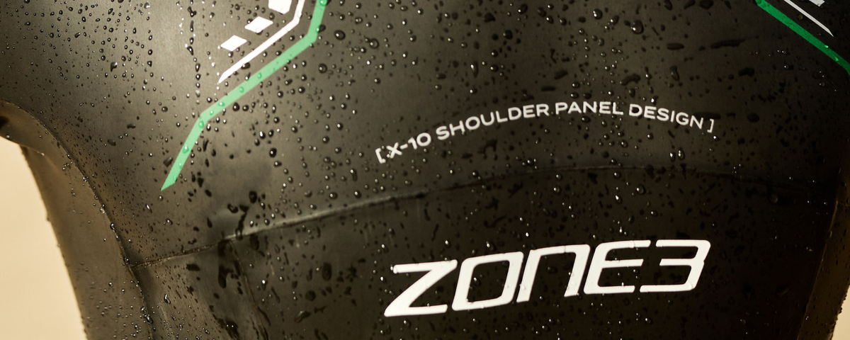 Zone3 swim suit with X-10 shoulder panel design on a wet surface