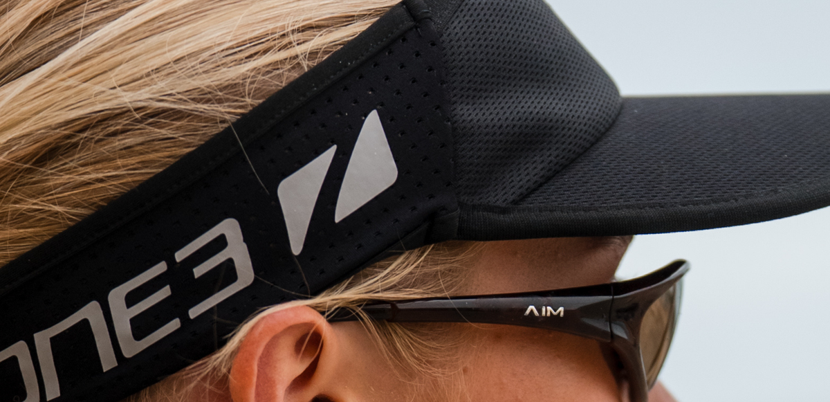 Close up of zone3 black running visor with a zone3 logo on a blurred background